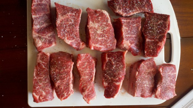 Pat the ribs dry with paper towels, then generously season with kosher salt and pepper.