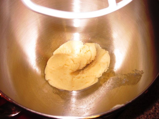 Push out as much of the water as possible on the stove, then transfer to a mixer.