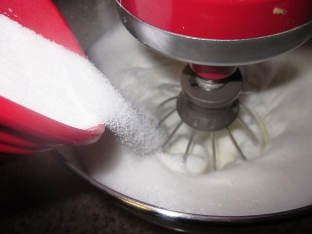 After beating the egg whites, add the sugar in a steady stream.